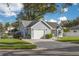 Light blue house with white garage door and manicured lawn at 3102 Jarvis St, Holiday, FL 34690