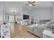 Open living room with gray sectional sofa and tile floors at 3102 Jarvis St, Holiday, FL 34690