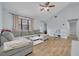 Spacious living area featuring a gray sectional sofa and tile floors at 3102 Jarvis St, Holiday, FL 34690