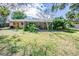 Large backyard with a screened porch and lush landscaping at 3230 San Bernadino St, Clearwater, FL 33759