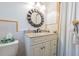 Updated bathroom with a granite vanity and a sunburst mirror at 3230 San Bernadino St, Clearwater, FL 33759