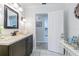 Modern bathroom with dark vanity and kitchen access at 3230 San Bernadino St, Clearwater, FL 33759