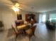 Bright dining area with glass table, four chairs, and built-in hutch at 3230 San Bernadino St, Clearwater, FL 33759