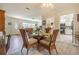 Bright dining area with a glass-top table and four chairs, open to kitchen at 3230 San Bernadino St, Clearwater, FL 33759