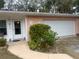 Front door entrance with walkway, landscaping, and attached garage at 3230 San Bernadino St, Clearwater, FL 33759