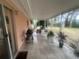 Screened porch with tile floor and potted plants at 3230 San Bernadino St, Clearwater, FL 33759