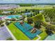 Aerial view of community amenities, including pool, playgrounds, and tennis courts at 3795 Morgons Castle Ct, Land O Lakes, FL 34638