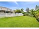 Grass backyard, white fence, and partial home view at 3795 Morgons Castle Ct, Land O Lakes, FL 34638