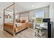 Bright bedroom featuring a canopy bed, workspace, and wood-look floors at 3795 Morgons Castle Ct, Land O Lakes, FL 34638