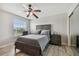 Serene bedroom with ceiling fan, dresser and large window at 3795 Morgons Castle Ct, Land O Lakes, FL 34638