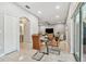 Bright dining area with glass table, leather chairs and view into living room at 3795 Morgons Castle Ct, Land O Lakes, FL 34638