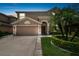 Two-story house with a two-car garage and landscaped front yard at night at 3795 Morgons Castle Ct, Land O Lakes, FL 34638