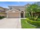 Two-story house with a two-car garage and landscaped front yard at 3795 Morgons Castle Ct, Land O Lakes, FL 34638