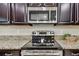 Stainless steel appliances and granite countertops highlight this modern kitchen at 3795 Morgons Castle Ct, Land O Lakes, FL 34638