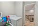 Bright laundry room with washer, dryer, and ample storage at 3795 Morgons Castle Ct, Land O Lakes, FL 34638