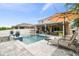 Luxury pool with patio, lounge chairs and umbrella at 3795 Morgons Castle Ct, Land O Lakes, FL 34638