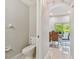 Clean powder room with toilet and view to hallway at 3795 Morgons Castle Ct, Land O Lakes, FL 34638