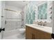 Spa-like bathroom with teal wallpaper, a soaking tub, and a vanity at 3815 W San Juan St, Tampa, FL 33629