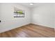 Simple bedroom with wood-look floors and wainscoting at 3815 W San Juan St, Tampa, FL 33629