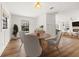 Bright dining room with hardwood floors, wainscoting, a stylish light fixture, and direct views of the living area at 3815 W San Juan St, Tampa, FL 33629