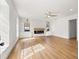 Bright living room with hardwood floors, a fireplace, and built-in shelving at 3815 W San Juan St, Tampa, FL 33629