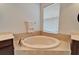 Relaxing bathroom with soaking tub and tile flooring at 402 Islebay Dr, Apollo Beach, FL 33572