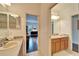 Double vanity bathroom with a view into bedroom at 402 Islebay Dr, Apollo Beach, FL 33572