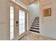 Elegant entryway with a chandelier and staircase at 402 Islebay Dr, Apollo Beach, FL 33572