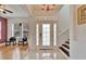 Bright entryway with hardwood floors, chandelier, and staircase at 402 Islebay Dr, Apollo Beach, FL 33572