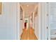 Hardwood floor hallway with artwork and natural light at 402 Islebay Dr, Apollo Beach, FL 33572