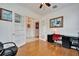 Home office with hardwood floors, red chair, and built in desk at 402 Islebay Dr, Apollo Beach, FL 33572