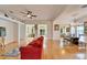 Open living space with red couch, hardwood floors, and views to the kitchen and sunroom at 402 Islebay Dr, Apollo Beach, FL 33572