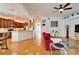 Open living space with red couch, hardwood floors, and views to the kitchen and sunroom at 402 Islebay Dr, Apollo Beach, FL 33572