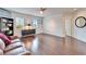 Bright loft with hardwood floors, a cozy couch, and built-in shelving at 402 Islebay Dr, Apollo Beach, FL 33572