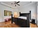 Main bedroom with king-size bed and hardwood floors at 402 Islebay Dr, Apollo Beach, FL 33572