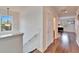 Upstairs hallway featuring hardwood floors and multiple rooms at 402 Islebay Dr, Apollo Beach, FL 33572