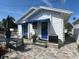 White house with blue awnings, patio furniture, and brick pavers at 410 W Lemon St, Tarpon Springs, FL 34689