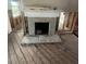 Fireplace with decorative tile surround and wood flooring at 410 W Lemon St, Tarpon Springs, FL 34689