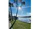 Tranquil waterfront view with palm trees and dock at 410 W Lemon St, Tarpon Springs, FL 34689