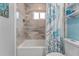 Bathroom with a shower/tub combo, tile surround, and ocean-themed decor at 4208 Harbor House Dr, Tampa, FL 33615