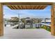 Private boat dock with covered lift and waterfront views at 4208 Harbor House Dr, Tampa, FL 33615