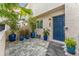 Modern townhouse with a blue front door and a stone patio with blue pots at 4208 Harbor House Dr, Tampa, FL 33615