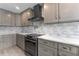 Modern kitchen with gray cabinets, quartz countertops, and stainless steel appliances at 4208 Harbor House Dr, Tampa, FL 33615