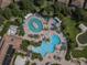 Aerial view of resort-style pools and surrounding landscape at 430 Cedar Falls Dr, Apollo Beach, FL 33572