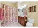 Bathroom with shower/tub combo and wood vanity at 430 Cedar Falls Dr, Apollo Beach, FL 33572