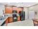 Kitchen with stainless steel appliances and wood cabinets at 430 Cedar Falls Dr, Apollo Beach, FL 33572