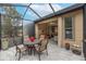 Covered patio with table and chairs, adjacent to the living room at 430 Cedar Falls Dr, Apollo Beach, FL 33572