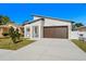 Contemporary home's exterior showcases a clean design and a brown garage door at 4351 56Th N Ave, St Petersburg, FL 33714