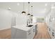 Modern kitchen with white cabinetry, quartz island, and stainless steel appliances at 4351 56Th N Ave, St Petersburg, FL 33714