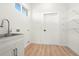 Laundry room with sink, shelving and modern finishes at 4351 56Th N Ave, St Petersburg, FL 33714